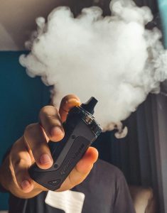 A man smoking a vape